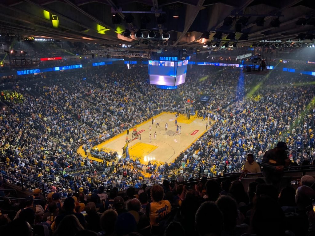 people watching a basketball game on a stadium