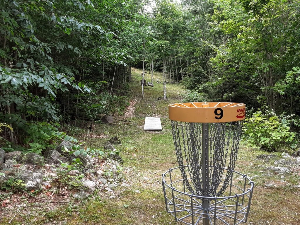 steep hill behind disc golf basket
