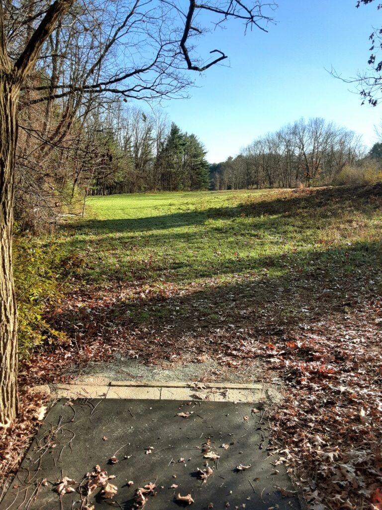 View of open field at Northampton State Hospital Disc Golf Course.