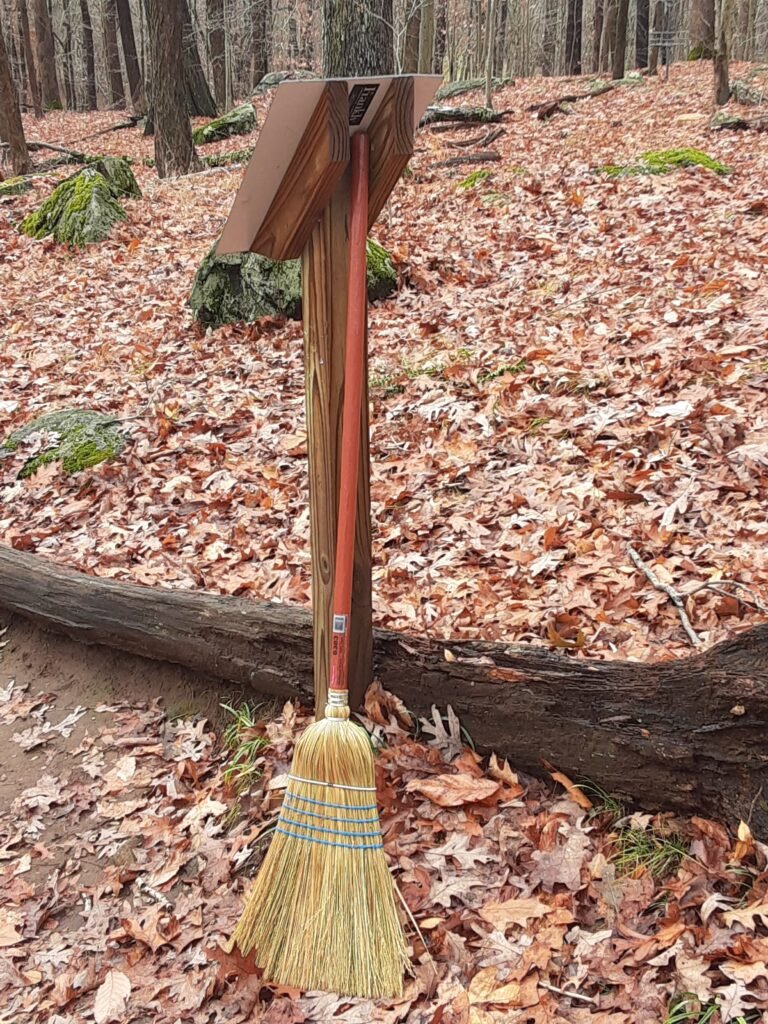 broom at disc golf tee pad